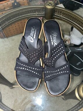 Onex Black Studded Slide Sandals with Tan bottoms.